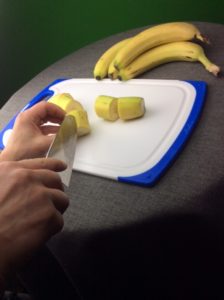 Cutting and removing the peel to prep the bananas