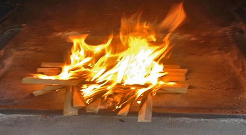 Open Pit cooking fire We built by using Smokinlicious ash wood to develop great coals for our ember cooking of Peppers