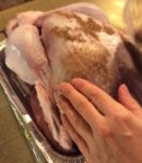 Gently placing the rub on the outside of the Turkey 