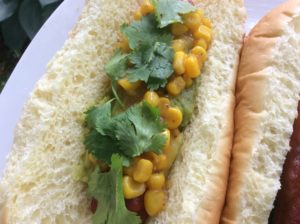 The dog from Mexico has fresh guacamole, corn, and fresh cilantro 