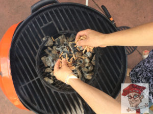 Grande Sapore-larger wood chips for smoking being applied to the grill 